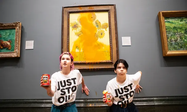 Just Stop Oil protesters glued themselves to the wall of the National Gallery in London and threw tomato soup at Vincent Van Gogh’s Sunflowers on 14 October 2022. Photograph: Antonio Olmos/The Guardian