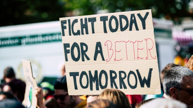 A photo of a protest sign reading Fight Today for a Better Tomorrow.