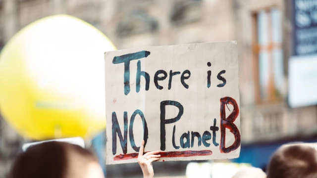 A photo of a protest sign that reads: There is NO Planet B.